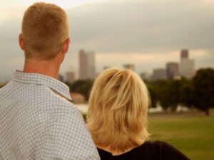 A professional couple enjoying the benefits of the lower Denver cost of living from their apartment.